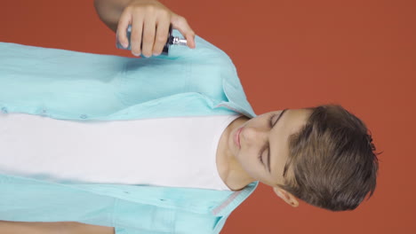 Vertical-video-of-The-boy-who-puts-on-perfume-and-smells-good.